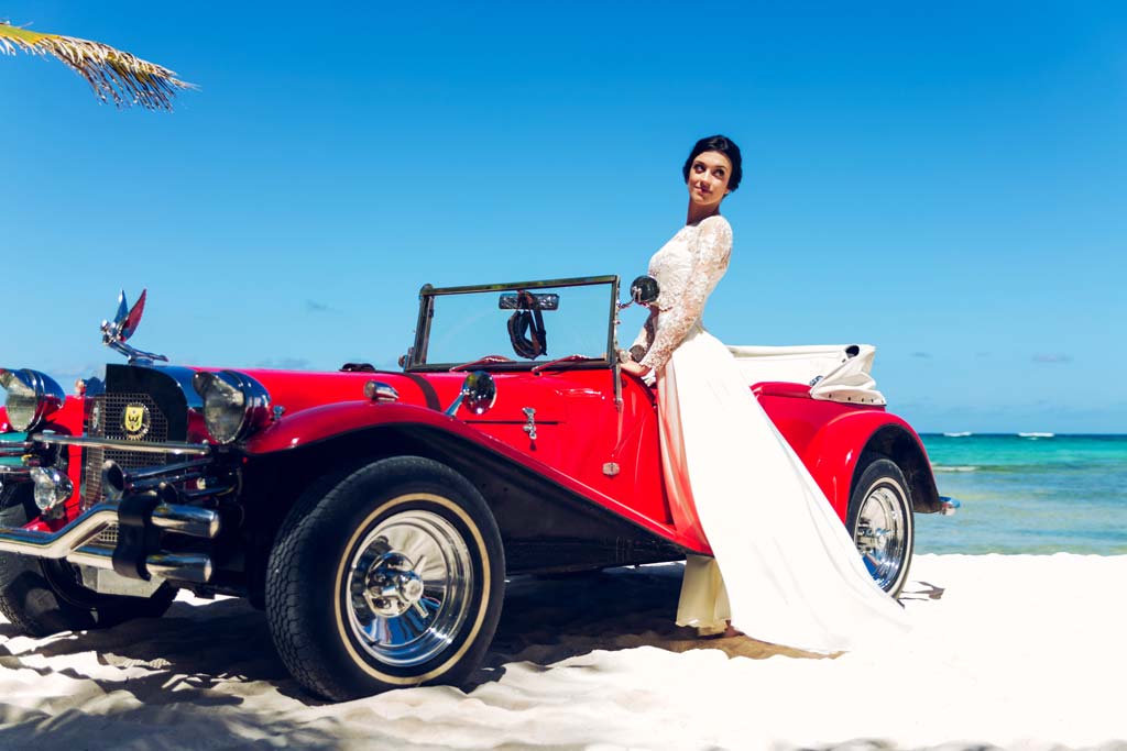 Photo of Woman Standing Near Classic Car