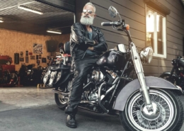 An elderly man confidently ready to ride his fixed and inspected salvage motorcycle purchased from RideSafely.