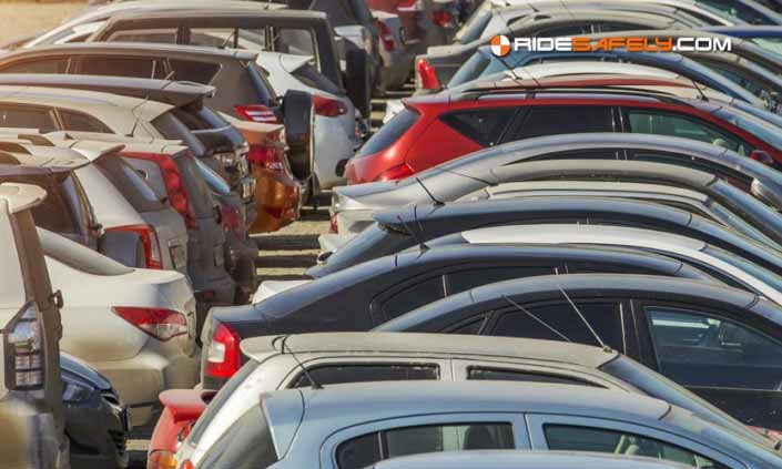Parked used cars stand on auction parking during the day