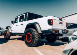 Bidding Wars: A Beginner's Guide to Online Auto Auctions | RideSafely — Auto Auctions Worldwide | RideSafely — Auto Auctions Worldwide White Jeep Gladiator parked at car auction