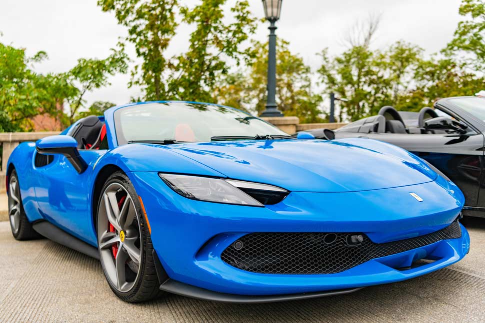 2024 Ferrari 296 GTS or GTB in blue, parked on the street, showcasing its sleek luxury design in Chicago.