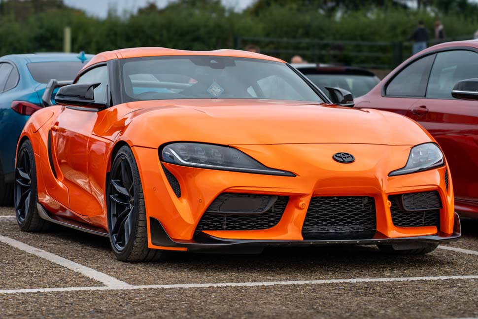 2024 Toyota GR Supra in bright orange, showcasing its bold design and high-performance capabilities.