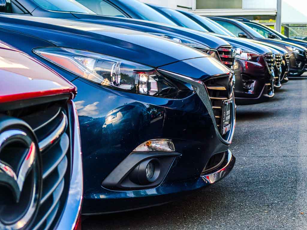 Row of Mazda 3 cars displayed at an online car auction.