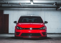 Red VW GTI car parked at a car auction.