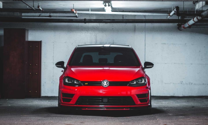 Red VW GTI car parked at a car auction.