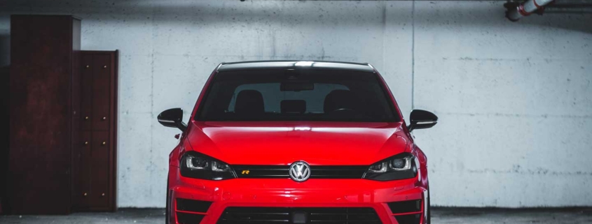 Red VW GTI car parked at a car auction.