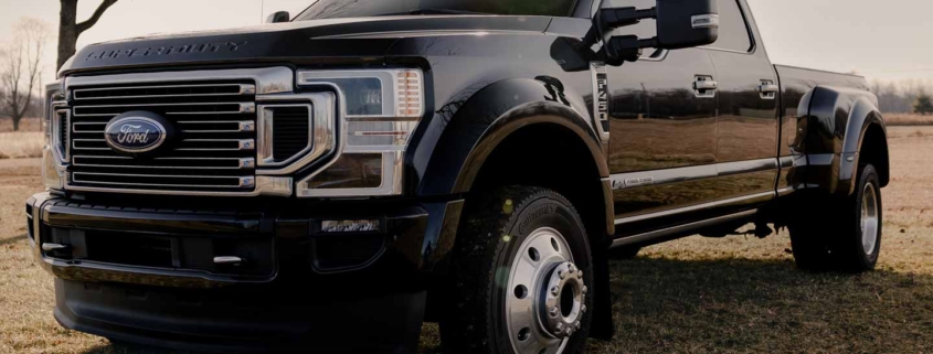 White Ford F-150 Crew Cab pickup truck on grass field, showcasing available options at online car auctions.
